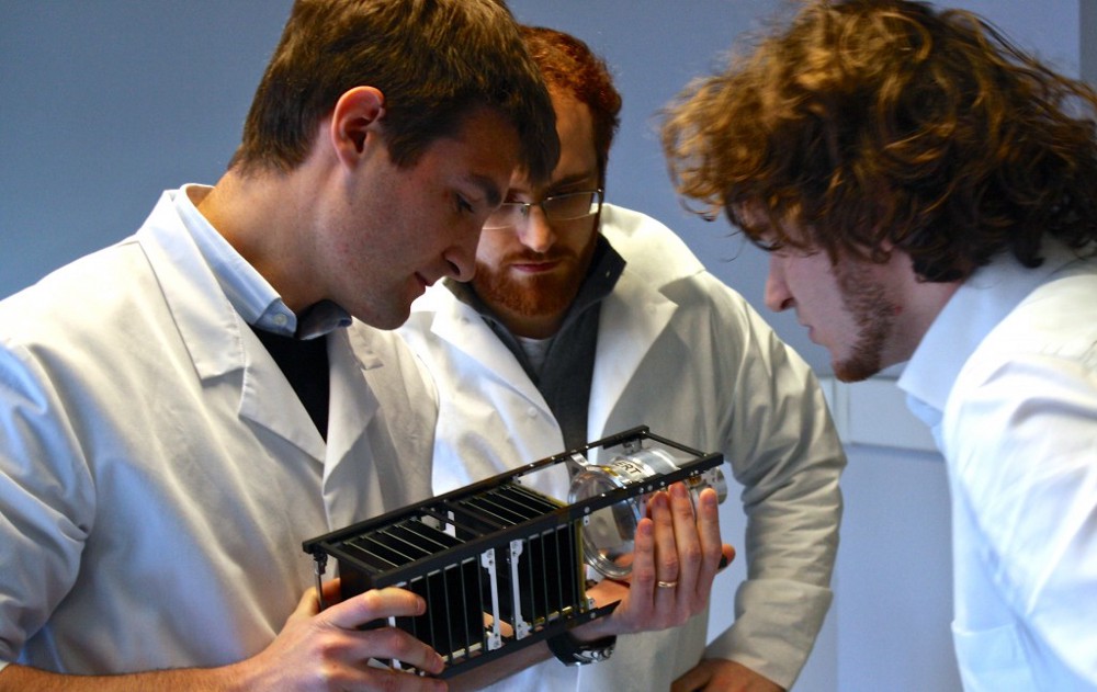 D-Orbit employees examining one of the company’s products.