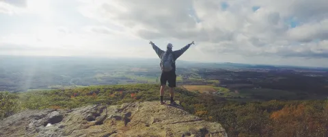 Man standing in Top of a Mountain