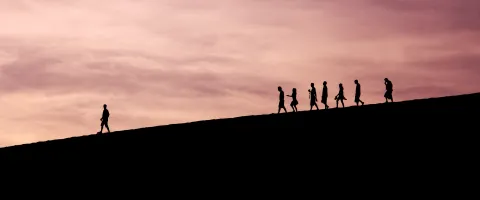People walking down a hill