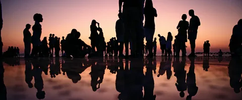 People standing together during sunset