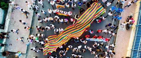 What Is Business Activism And How To Get Started With It A crowd is walking on the street with colourful banners