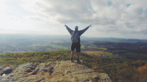 Man standing in Top of a Mountain