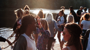 Crowd of people standing by a lake