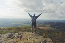 Man standing in Top of a Mountain