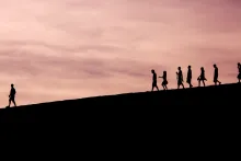 People walking down a hill