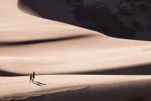 Two People Walking Through the Desert