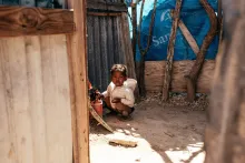 Small child inside of a home in a poor area