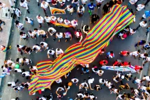 What Is Business Activism And How To Get Started With It A crowd is walking on the street with colourful banners